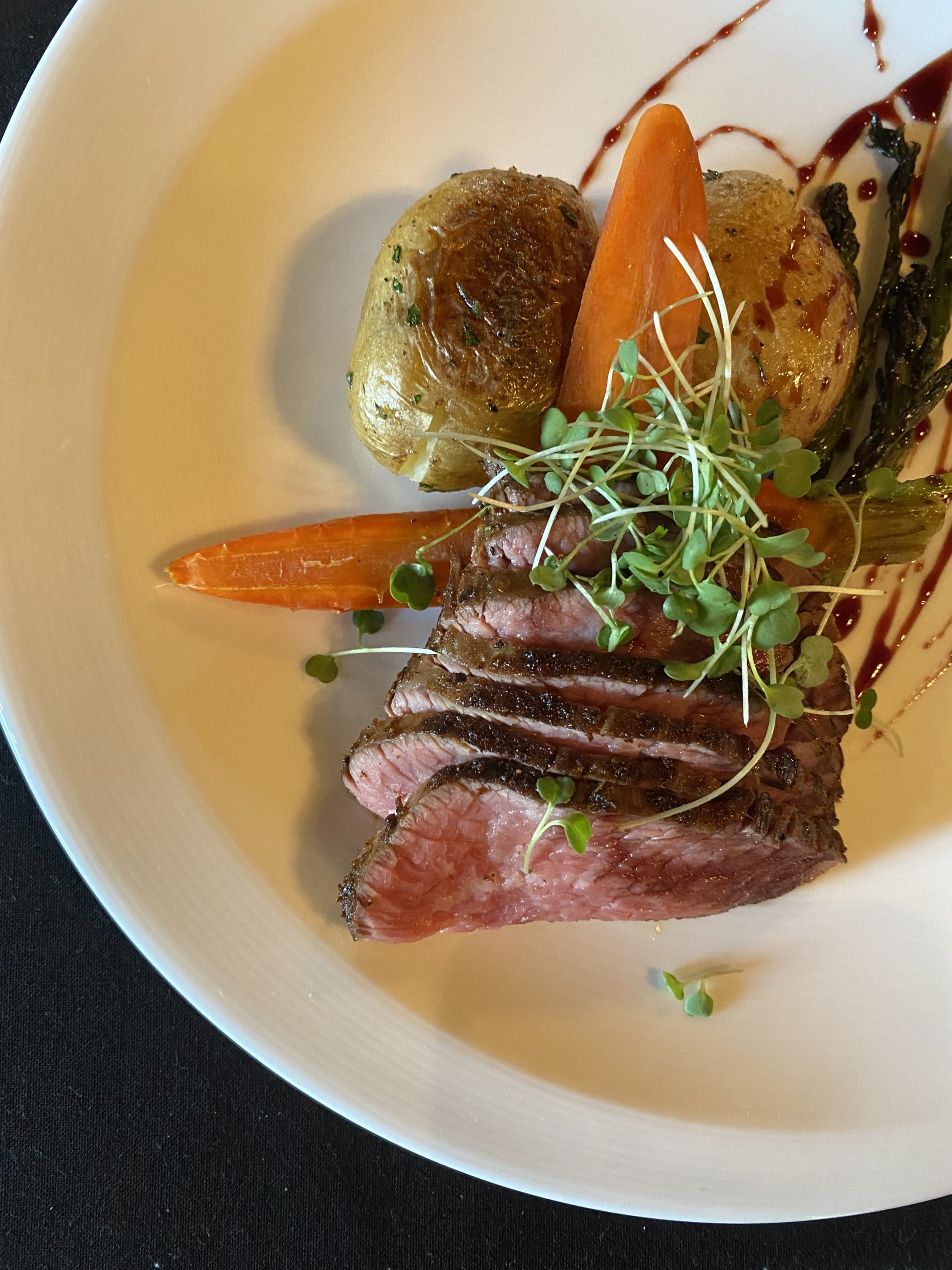 A beautiful spice seared Angus sirloin with Trione red wine glazed baby carrots, roasted delta asparagus, brown clamshell mushrooms, and a rich demi glace.